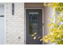 Gray front door with glass panel and smart lock, adds curb appeal at 7573 Knoll Hollow Rd, Lithonia, GA 30058