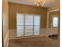 Bright dining room with large windows and neutral colored walls at 6005 Pattingham Dr, Roswell, GA 30075