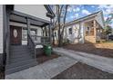 Welcoming front porch with dark gray railings and steps at 576 Rockwell Sw St, Atlanta, GA 30310