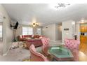 Open concept dining area with glass table and pink chairs at 3361 Highway 3 N, Hampton, GA 30228