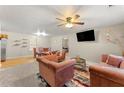 Spacious living room featuring plush sofas and a large TV at 3361 Highway 3 N, Hampton, GA 30228
