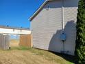 Townhome side yard with wooden fence and grassy area at 1625 Conley Rd # 229, Conley, GA 30288