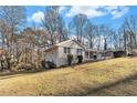 Side view of the house showcasing the gray brick exterior and backyard at 2702 Norma Cir, Decatur, GA 30034