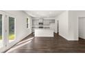 Open concept kitchen with gray cabinets and hardwood floors at 145 Bonito Trl, Covington, GA 30016