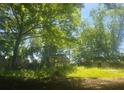 Overgrown lot with partial view of dilapidated shed and house remains at 180 Wallace Dr, Atlanta, GA 30354