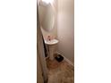 Small bathroom with pedestal sink and oval mirror at 1771 Fielding Way, Hampton, GA 30228