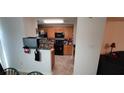 Kitchen with wooden cabinets and black appliances at 1771 Fielding Way, Hampton, GA 30228