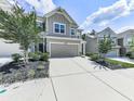 Two-story townhome with gray siding, landscaping, and a two-car garage at 5512 Cascade Run, South Fulton, GA 30336