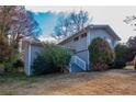 Gray sided house with white steps and landscaping at 4557 Greenleaf Sw Cir, Atlanta, GA 30331