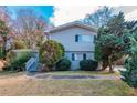 Two story house with gray siding, landscaping, and walkway at 4557 Greenleaf Sw Cir, Atlanta, GA 30331