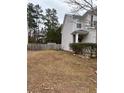 Side view of two-story house with gray siding, and a wooden fence at 105 Birch St, Hiram, GA 30141