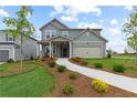 Two-story house with gray siding, landscaping, and a two-car garage at 3340 Redwood Ct, Covington, GA 30016