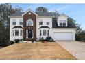 Two-story house with brick and vinyl siding, a large yard, and a two-car garage at 9985 Rivercliff Ln, Villa Rica, GA 30180