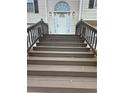 Brown stained wooden stairs leading to the front door at 360 Chestnut Dr, Covington, GA 30016