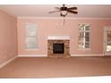 Spacious living room featuring a fireplace and neutral carpeting at 8178 Lochley Dr, Fairburn, GA 30213