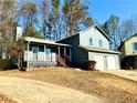 Newly painted two-story house with a two-car garage and a porch at 3945 Peninsula Ct, Lawrenceville, GA 30044