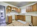 Kitchen with wood cabinets and vinyl flooring needing updates at 1743 Marcel Sw Ave, Atlanta, GA 30311