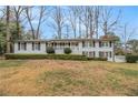 Gray brick ranch home with a covered porch and mature trees at 2418 Brookdale Ne Dr, Atlanta, GA 30345