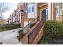 Front entry with brick stairs and black metal railing at 5877 Riverstone Cir # 17, Atlanta, GA 30339