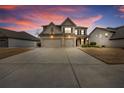 Two-story house with three car garage, nighttime view at 2925 Bluestone Sw Dr, Atlanta, GA 30331