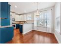 Modern kitchen with granite countertops and teal cabinetry at 60 Stonecrest Dr, Dallas, GA 30157