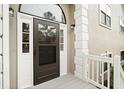 Brown front door with a storm door and white trim at 6764 Creek Valley Way, Douglasville, GA 30134