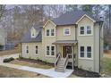 Two-story house, light beige siding, dark gray roof, and a landscaped yard at 2170 Charleston Pl, Lithia Springs, GA 30122
