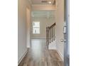 Bright and airy entryway with hardwood floors and an open staircase at 608 Somerset Ct, Loganville, GA 30052