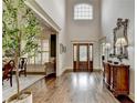 Two-story foyer with hardwood floors, chandelier, and antique furniture at 3006 Cambridge Hill Dr, Dacula, GA 30019