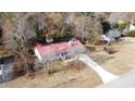 Aerial view of a house with a red metal roof and a large yard at 70 E Honeysuckle Ln, Carrollton, GA 30116