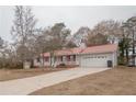 Gray house with red metal roof, shutters, and a long driveway at 70 E Honeysuckle Ln, Carrollton, GA 30116
