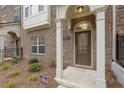 Townhome entrance with a brown door and arched entryway at 2065 Morrison Ave, Brookhaven, GA 30319