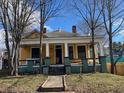 Yellow house with wrap-around porch and mature trees at 1786 Lakewood Ave, Atlanta, GA 30315
