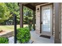 Front entrance of townhome with brick facade and landscaping at 5531 Radford Loop, Fairburn, GA 30213