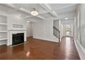 Living room with hardwood floors, fireplace, and high ceilings at 5531 Radford Loop, Fairburn, GA 30213