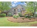 Two-story brick home with landscaped yard and stone accents at 3520 Moye Trl, Duluth, GA 30097