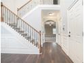 Elegant staircase with wrought iron railing and hardwood floors at 1609 Richmond Meadow Ct, Loganville, GA 30052