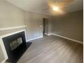 Living room with fireplace and wood-look floors at 5787 Summerglenn Ln, Atlanta, GA 30349