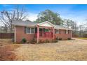 Red brick ranch house, covered porch, gravel driveway at 3890 Kemp Ridge Rd, Acworth, GA 30101