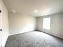 Simple bedroom with gray carpeting and a window at 446 Rodeo Dr, Auburn, GA 30011