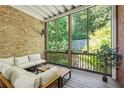 Relaxing screened porch with comfy seating and view of wooded backyard at 5920 Reddington Way, Sandy Springs, GA 30328