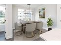 Modern dining room with a six-seat table and access to the kitchen at 353 Skylar Se Way, Atlanta, GA 30315