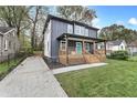 Two-story house with gray siding, a blue door, and a wooden porch at 2447 Lynn Iris Dr, Decatur, GA 30032