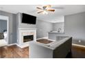 Living room with fireplace, hardwood floors, and gray sofa at 1203 Willow Nw Ct, Kennesaw, GA 30152