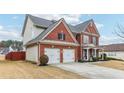 Brick two-story house with a two-car garage and landscaped yard at 3077 Eastbrook Sw Ter, Atlanta, GA 30331