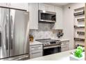 Modern kitchen with stainless steel appliances and white cabinets at 3201 Lenox Ne Rd # 23, Atlanta, GA 30324