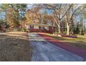 Ranch style home nestled among trees, featuring a long driveway at 2256 Fleur Se Dr, Marietta, GA 30060