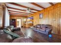 Spacious living area with wood paneling, exposed beams, and dark hardwood floors at 2256 Fleur Se Dr, Marietta, GA 30060