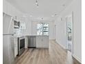 Open concept kitchen features stainless steel appliances and hardwood floors at 525 Parkway Ne Dr # 217, Atlanta, GA 30308