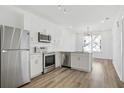Modern kitchen with stainless steel appliances and white cabinets at 525 Parkway Ne Dr # 217, Atlanta, GA 30308